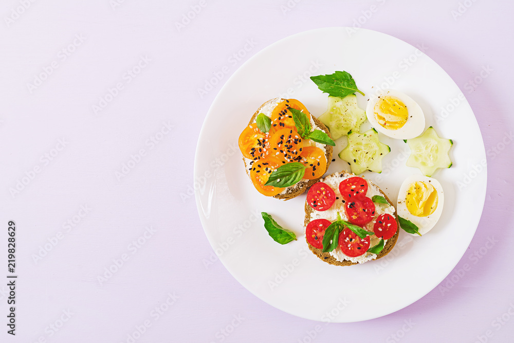 Breakfast. Sandwich with cream cheese with tomatoes and cream cheese. Top view. Flat lay Breakfast. Sandwich with cream cheese with tomatoes and cream cheese. Top view. Flat lay