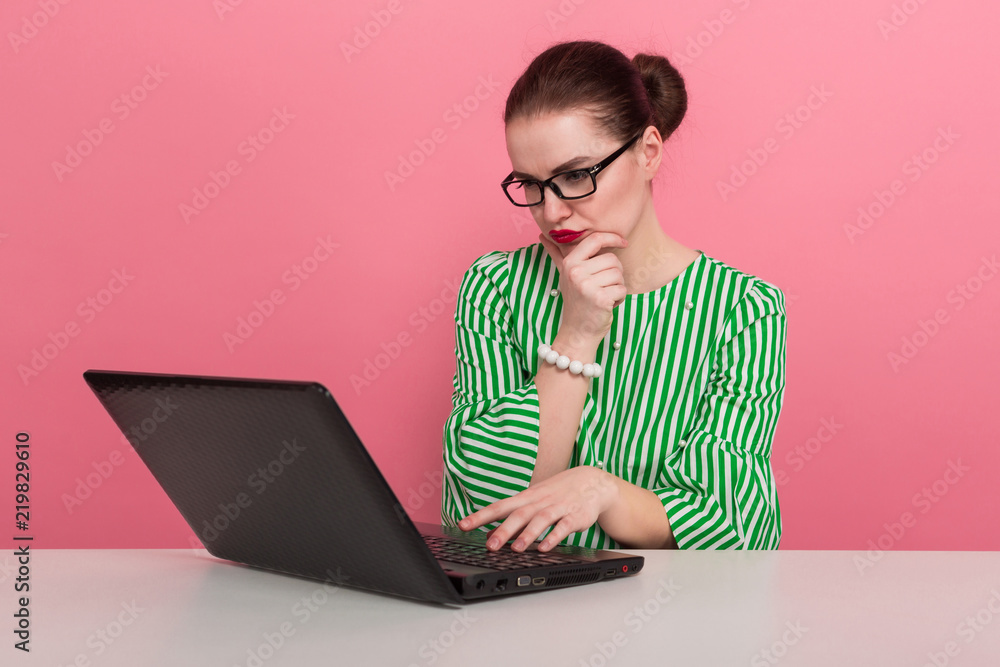 Businesswoman with hair bun and laptop Businesswoman with hair bun and laptop