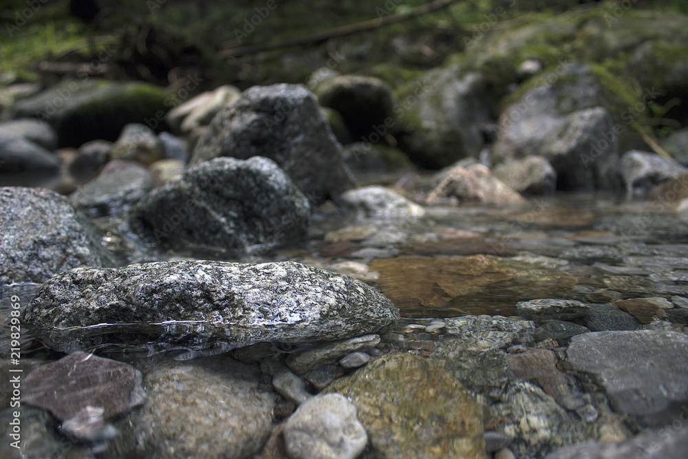 Through clear water you can see the stones. river spring water. colored stones. Crystal clear water in the waterfall. Through clear water you can see the stones. river spring water. colored stones. Crystal clear water in the waterfall.