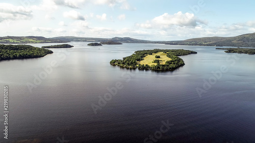 Aerial image of islands on Loch Lomond and hills in the distance on a bright summer’s day. © TreasureGalore