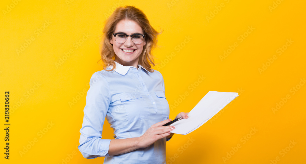 Fototapeta premium Blonde woman with blank paper and pen