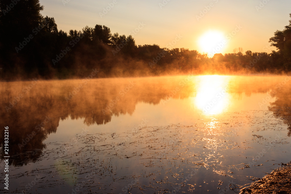 View of river in the mist at sunrise. Fog over river at morning View of river in the mist at sunrise. Fog over river at morning