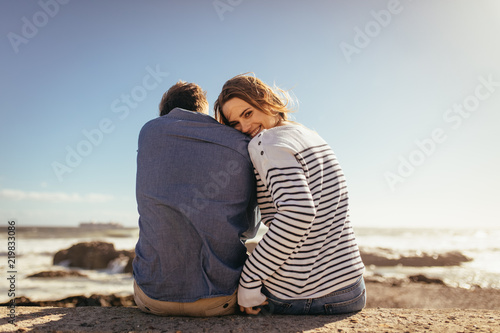 Couple sitting on a sea wall together