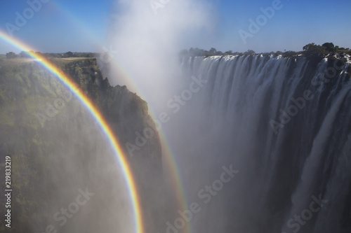 Rainbow near magnificent waterfall