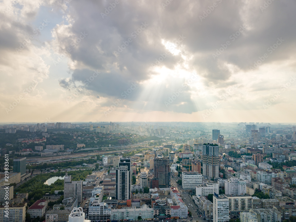 Panoramic view to a central part of Kiev, Ukraine with modern buildings on a cloudy sunset background in the summer. Aerial view from drone.