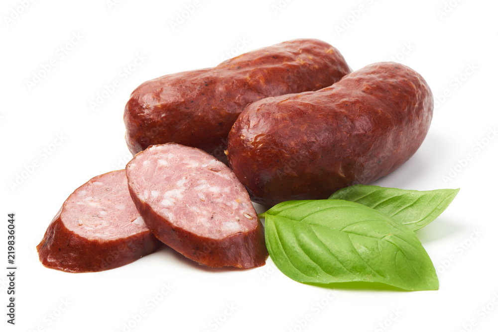 Bratwurst smoked pork sausages with sausage slices and green fresh basil leaves, isolated on white background. Bratwurst smoked pork sausages with sausage slices and green fresh basil leaves, isolated on white background.