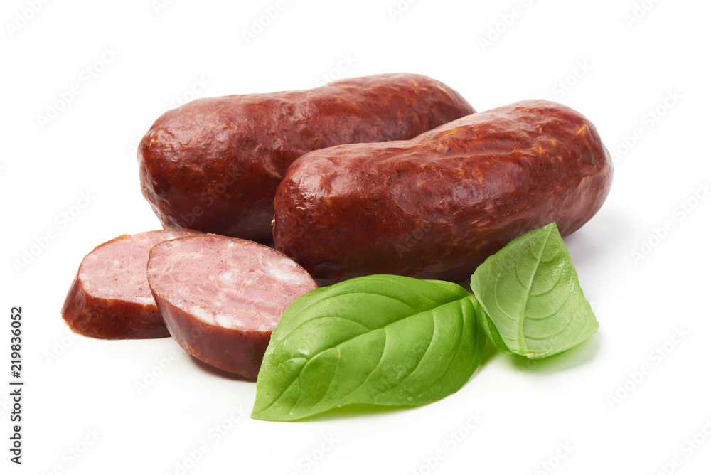 Bratwurst smoked pork sausages with sausage slices and green fresh basil leaves, isolated on white background. Bratwurst smoked pork sausages with sausage slices and green fresh basil leaves, isolated on white background.