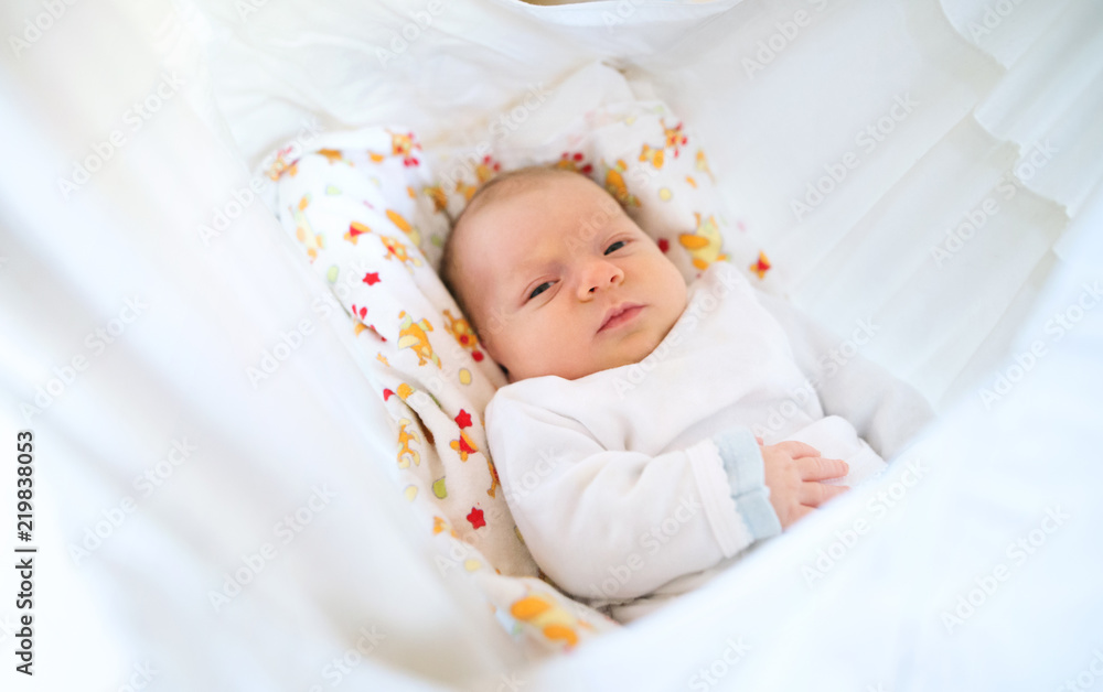 Cute happy newborn baby lying on bed. Cute happy newborn baby lying on bed.