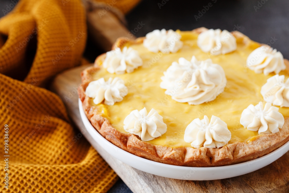 Traditional shortcrust pastry lemon tart with citrus custard and whipped cream Traditional shortcrust pastry lemon tart with citrus custard and whipped cream