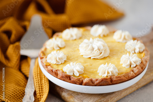 Traditional shortcrust pastry lemon tart with citrus custard and whipped cream