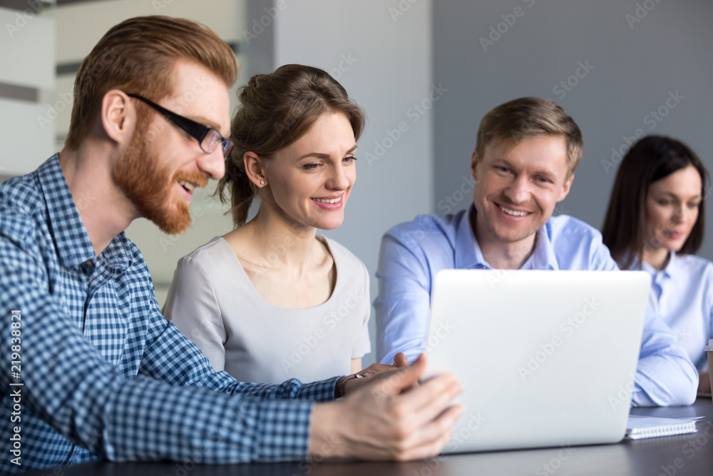 Happy diverse employees watching funny video at laptop during work break in  office, male worker showing startup plan or presenting bright idea to  excited coworkers during team meeting or briefing Stock Photo |