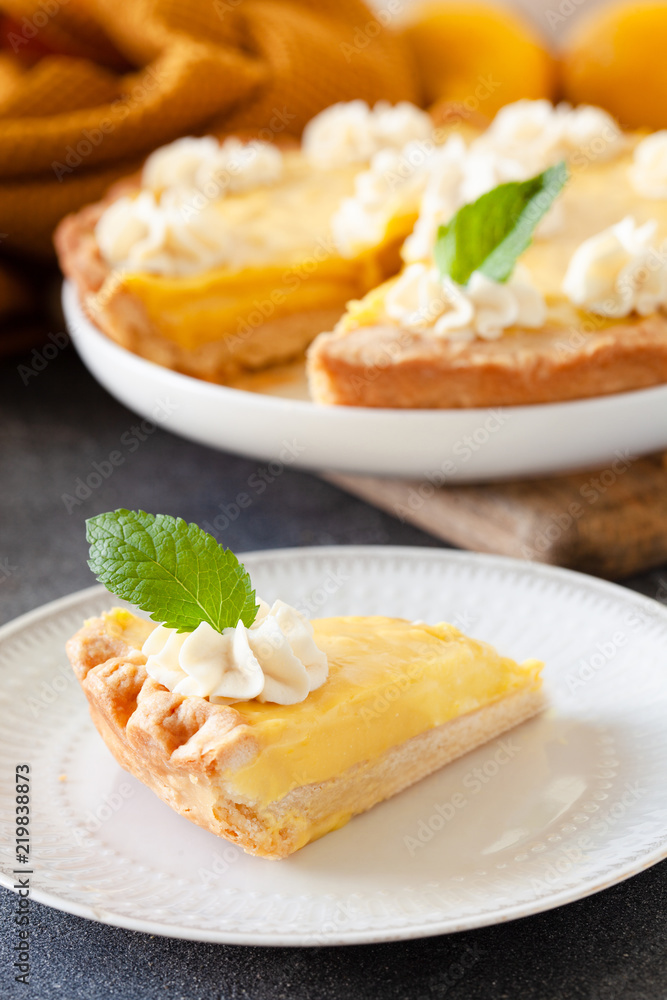 Traditional shortcrust pastry lemon tart with citrus custard and whipped cream Traditional shortcrust pastry lemon tart with citrus custard and whipped cream