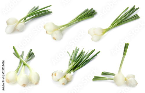 Set with fresh green onion on white background