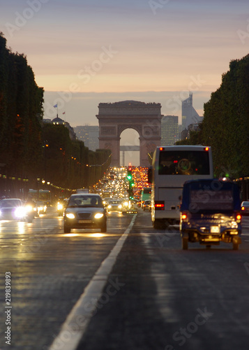 sunset scene in Paris city. Long exposure photo of street traffic near Arc de Triomphe, Champs Elysees boulevard. © Ioan Panaite