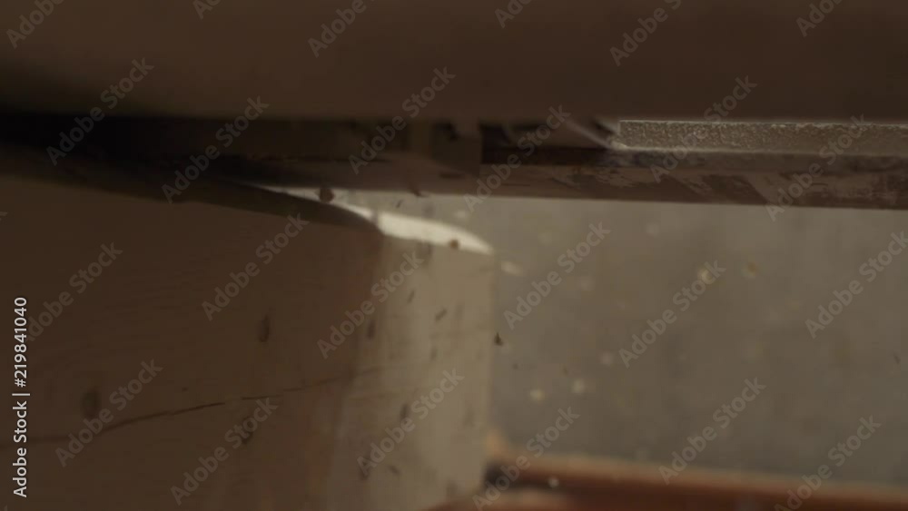 Slow-motion shooting flying sawdust from under the sander close-up Slow-motion shooting flying sawdust from under the sander close-up