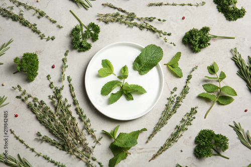 Flat lay composition with aromatic herbs on table