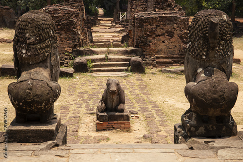 Ancient temple stone monument in Angkor Wat complex, Cambodia. Nandi bull and lion statue. Hindu temple sculpture. photo