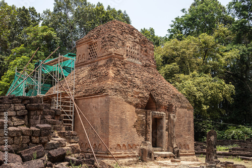 Ancient stone ruins of Preah Koh temple, Roluos, Cambodia. Old sandstone buddhist stupa. Archaeological site. photo