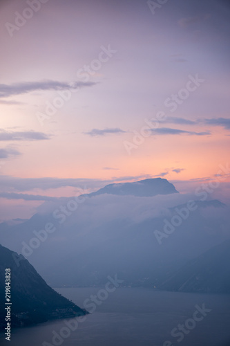 Panorama of Lake Garda (Northern Italy) at sunset with low clouds