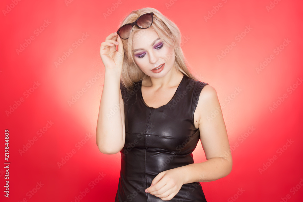 Fototapeta premium Stylish blond woman in black leather dress