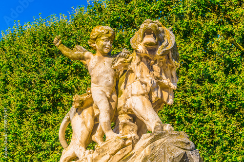 Statue of a boy and a lion at la Promenade du Peyrou in Montpellier, France photo
