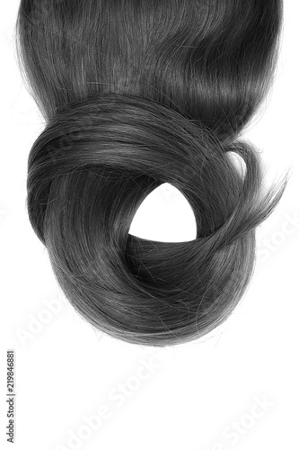 Black hair isolated on white background. Long beautiful ponytail in shape of circle