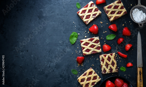 Strawberry cakes with strawberry fruits on dark background.