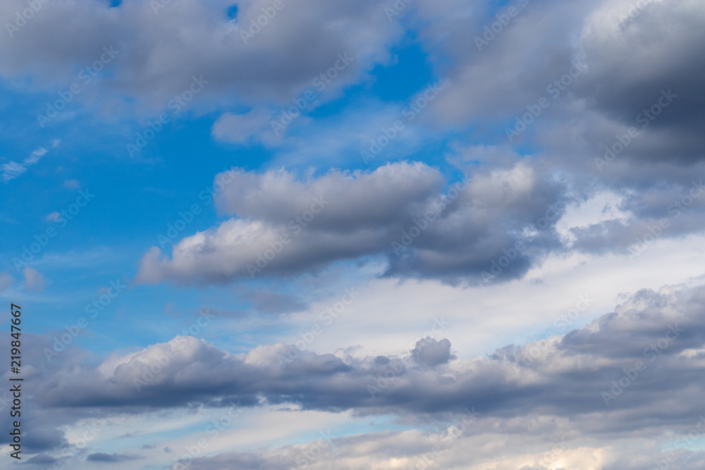 Grey clouds in front of blue sky in summer