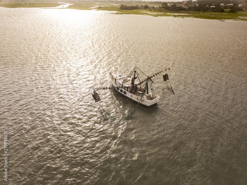 Aerial view of shrimp boat off the coast of South Carolina at sunrise,