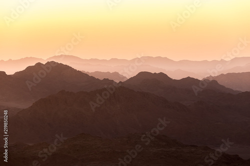 Rising sun and Sinai mountains dramatic landscape view (Mount Horeb, Gabal Musa, Moses Mount). photo