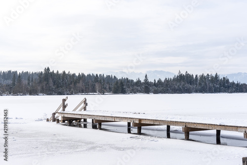 Stage in of frozen Kirchsee lake, Bavaria, with Alps in background,  in winter © irottlaender
