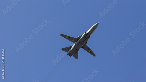fighter flies against the blue sky, military aircraft