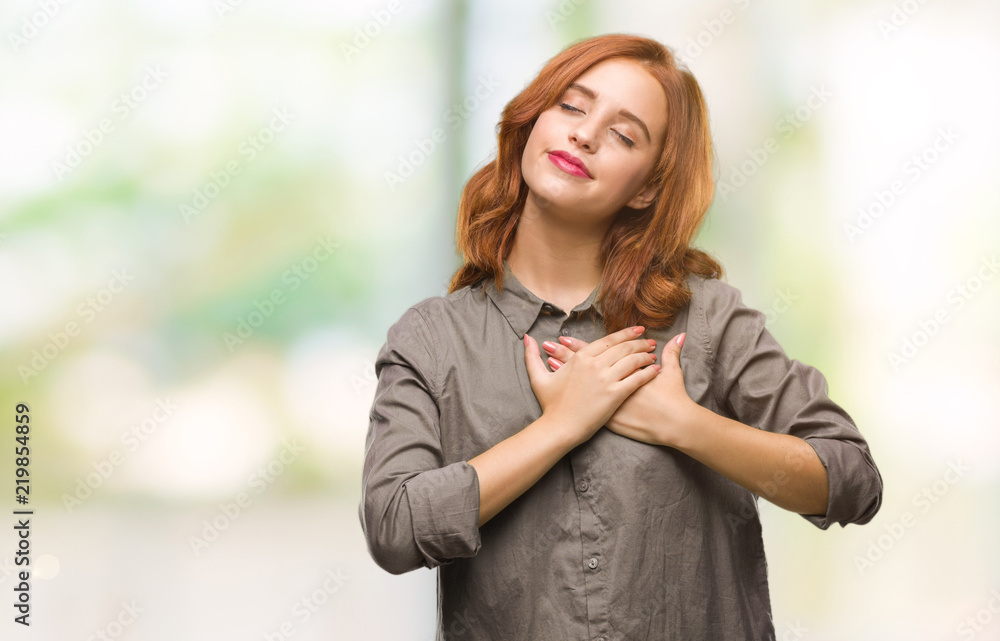 Young beautiful woman over isolated background smiling with hands on chest with closed eyes and grateful gesture on face. Health concept. Young beautiful woman over isolated background smiling with hands on chest with closed eyes and grateful gesture on face. Health concept.