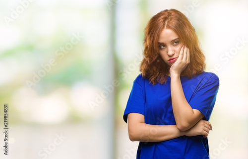 Young beautiful woman over isolated background thinking looking tired and bored with depression problems with crossed arms. © Krakenimages.com