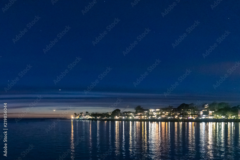 marina nights at dusk time with calm waters and lush landscape