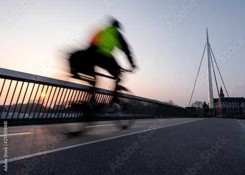 Cyclist on a bicycle bridge in Odense, Denmark.