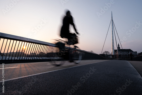 Cyclist on a bicycle bridge in Odense, Denmark. photo