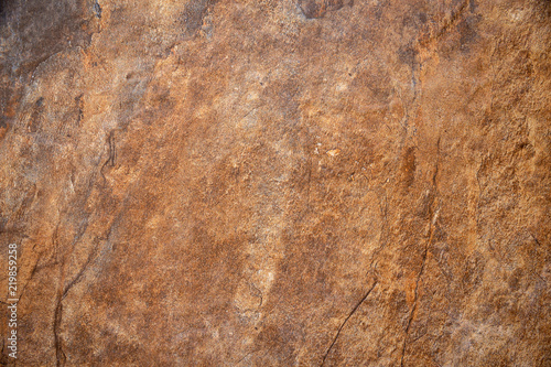 Textured surface of the marble rock with brown tint background