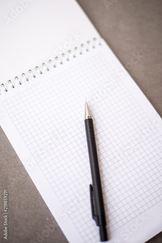 the notebook lies black pencil on the diagonal of the sheet