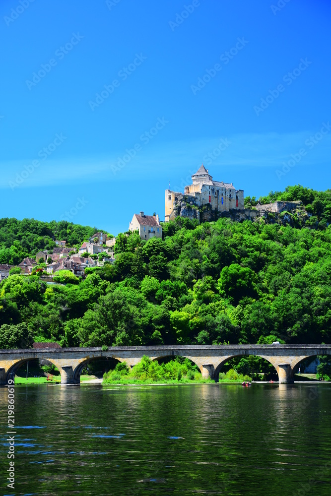 The medieval fortress and village of Castelnaud-la-Chapelle as seen from the Dordogne River in Aquitaine, France
