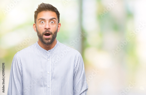 Adult hispanic man over isolated background afraid and shocked with surprise expression  fear and excited face.