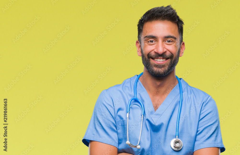 Adult hispanic doctor or surgeon man over isolated background happy face smiling with crossed arms looking at the camera. Positive person. Adult hispanic doctor or surgeon man over isolated background happy face smiling with crossed arms looking at the camera. Positive person.