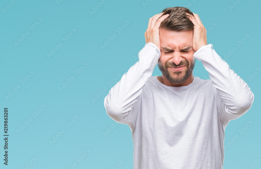 Young handsome man over isolated background suffering from headache desperate and stressed because pain and migraine. Hands on head. Young handsome man over isolated background suffering from headache desperate and stressed because pain and migraine. Hands on head.