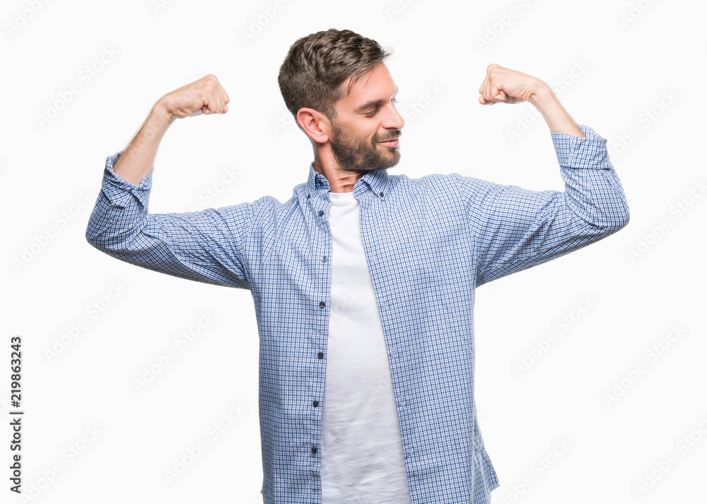 Young handsome man wearing white t-shirt over isolated background showing arms muscles smiling proud. Fitness concept. Young handsome man wearing white t-shirt over isolated background showing arms muscles smiling proud. Fitness concept.
