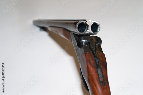 Double Barrel Shotgun with an Open Breach on White Background