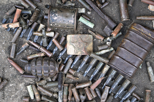 Military background with weapons trophies. The Second World War of Germany with the USSR and the countries of Europe. Coat of arms of the Soviet Union on a belt buckle.