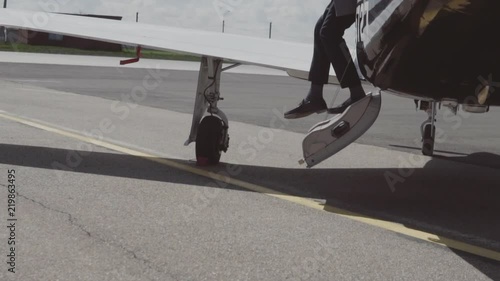the man leaves the private plane and goes to the car