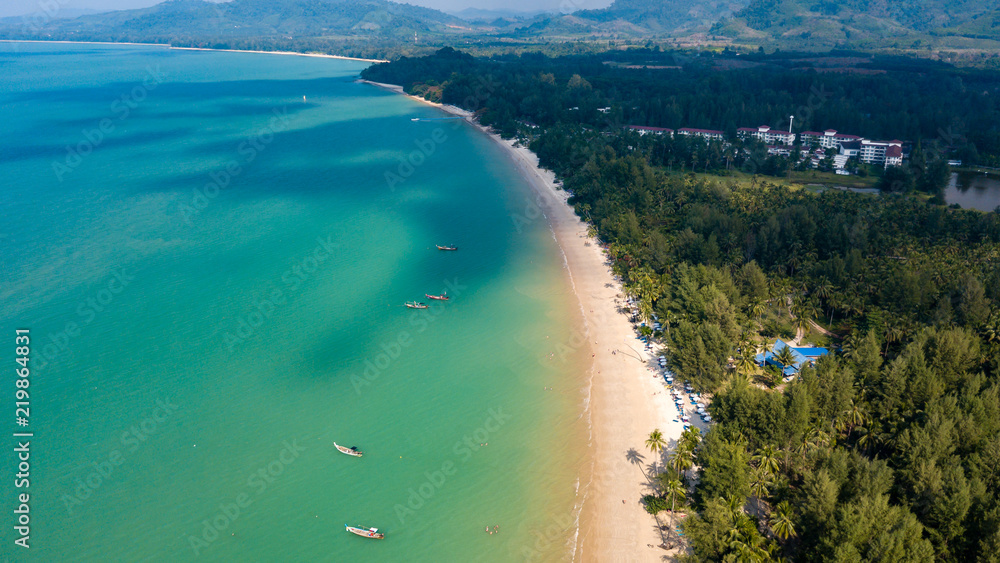 Fototapeta premium Aerial drone view of a beautiful empty sandy beach and tropical coastline