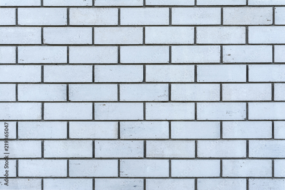 texture of a wall from a natural white brick with small cracks and chips, close-up abstract background texture of a wall from a natural white brick with small cracks and chips, close-up abstract background