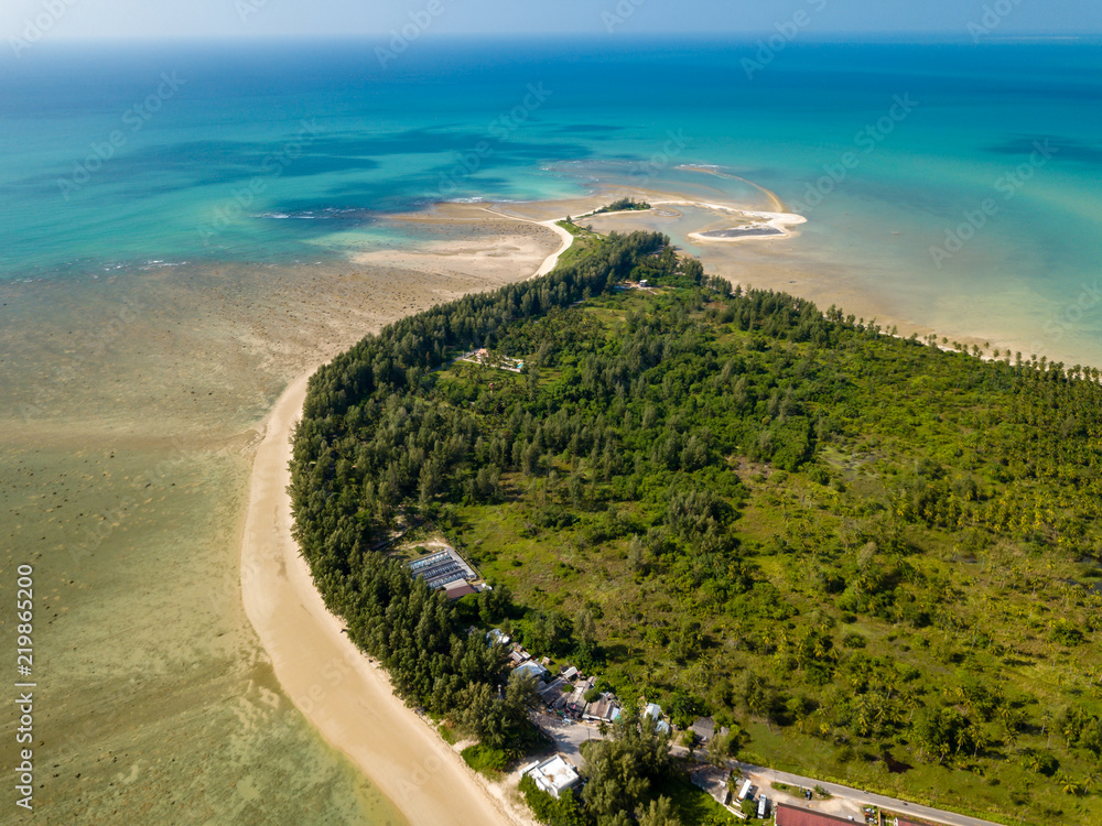 Aerial drone view of a sandy beach and shallow ocean (Cape Pakarang, Khao Lak, Thailand)